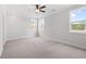 Bright bedroom with a ceiling fan and large windows, offering natural light at 7675 Homer Dr, Cumming, GA 30028