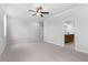 Spacious bedroom with neutral carpet, ceiling fan, and ensuite bathroom at 7675 Homer Dr, Cumming, GA 30028
