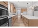 Spacious kitchen featuring stainless appliances, granite countertops, custom cabinetry, and luxury vinyl plank flooring at 7675 Homer Dr, Cumming, GA 30028
