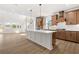 Open-concept kitchen featuring a large island, stainless steel appliances, and modern lighting fixtures at 7675 Homer Dr, Cumming, GA 30028
