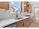 Close up on counter space featuring granite countertops, stainless steel appliances, subway tile, and modern cabinetry at 7675 Homer Dr, Cumming, GA 30028