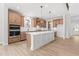 Modern kitchen featuring a large island, stainless steel appliances, custom cabinetry, and a breakfast area at 7675 Homer Dr, Cumming, GA 30028