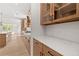 Open kitchen featuring stainless appliances, granite countertops, custom cabinetry, and luxury vinyl plank flooring at 7675 Homer Dr, Cumming, GA 30028