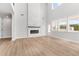 Bright and airy living room featuring hardwood floors, a modern fireplace, and plenty of natural light at 7675 Homer Dr, Cumming, GA 30028