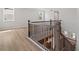 Elegant staircase with stained wood handrail and black iron balusters, providing safe access to upper level at 7675 Homer Dr, Cumming, GA 30028