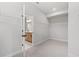 Spacious walk-in closet with wire shelving and view to bathroom, offering ample storage space at 7675 Homer Dr, Cumming, GA 30028