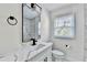 Modern bathroom with marble countertop, black matte faucet, and white tile at 2502 Tupelo Se St, Atlanta, GA 30317