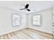 Bright bedroom with ceiling fan, wood-look floors, and two windows at 2502 Tupelo Se St, Atlanta, GA 30317