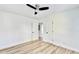 Spacious bedroom with hardwood floors and ceiling fan; access to hallway at 2502 Tupelo Se St, Atlanta, GA 30317