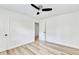 Bright bedroom with ceiling fan and wood-look floors, and door to hallway at 2502 Tupelo Se St, Atlanta, GA 30317