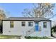 Charming ranch home with white brick exterior, blue door, and modern metal railing at 2502 Tupelo Se St, Atlanta, GA 30317