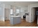 Bright kitchen featuring white cabinets, quartz countertops, and a spacious island at 2502 Tupelo Se St, Atlanta, GA 30317