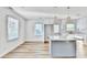 Modern kitchen with white cabinets, quartz countertops, and a large island at 2502 Tupelo Se St, Atlanta, GA 30317