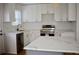 Modern white kitchen with stainless steel appliances and quartz countertops at 2502 Tupelo Se St, Atlanta, GA 30317