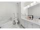 Double vanity bathroom with marble tile and soaking tub at 375 Highland Ne Ave # 908, Atlanta, GA 30312