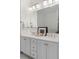 Bathroom boasts double vanity and elegant light fixtures at 375 Highland Ne Ave # 908, Atlanta, GA 30312