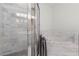 Spa-like bathroom with a glass shower and marble tile at 375 Highland Ne Ave # 908, Atlanta, GA 30312