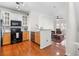 Open concept kitchen with granite countertops and hardwood floors at 375 Highland Ne Ave # 908, Atlanta, GA 30312