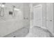 Stylish shower with marble walls, mosaic tile floor, and modern fixtures at 212 Sessions St, Woodstock, GA 30188