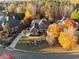Stunning aerial view of a red brick home with a circular driveway surrounded by colorful fall foliage at 2195 Lake Shore Lndg, Alpharetta, GA 30005