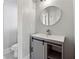 Cozy bathroom with a round mirror and modern vanity at 2195 Lake Shore Lndg, Alpharetta, GA 30005