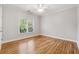 Bright bedroom with hardwood floors and a large window at 2195 Lake Shore Lndg, Alpharetta, GA 30005