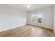 Bedroom with hardwood floors and two windows offering an exterior view at 2195 Lake Shore Lndg, Alpharetta, GA 30005