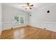 Spacious bedroom offering natural light from a large window and hardwood floors at 2195 Lake Shore Lndg, Alpharetta, GA 30005