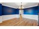 Chic dining room featuring hardwood floors, wainscoting, and a stylish chandelier at 2195 Lake Shore Lndg, Alpharetta, GA 30005