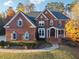 Charming brick home with manicured front lawn and inviting entryway showcasing classic design at 2195 Lake Shore Lndg, Alpharetta, GA 30005
