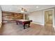 Spacious game room features a pool table, recessed lighting, and stylish wood accent wall at 2195 Lake Shore Lndg, Alpharetta, GA 30005