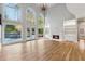 Spacious living room featuring tall windows, fireplace with white mantel, and hardwood floors at 2195 Lake Shore Lndg, Alpharetta, GA 30005