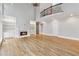 Open living room with hardwood floors, fireplace, and white built-in shelving at 2195 Lake Shore Lndg, Alpharetta, GA 30005