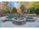 Beautiful outdoor retreat with stone-accented pool and hot tub surrounded by lush landscaping at 2195 Lake Shore Lndg, Alpharetta, GA 30005