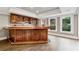 The wet bar features beautiful wood cabinetry, countertop, sink, and space for entertaining at 2195 Lake Shore Lndg, Alpharetta, GA 30005