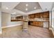 The wet bar has rich cabinetry, tile backsplash, appliances, and a full mirror at 2195 Lake Shore Lndg, Alpharetta, GA 30005
