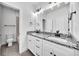 Bright bathroom boasts double granite vanity, white cabinets and modern fixtures at 1664 Crestridge Se Dr, Marietta, GA 30067