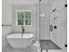 Bathroom features a soaking tub, glass shower, and modern fixtures at 1664 Crestridge Se Dr, Marietta, GA 30067