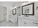 Bright bathroom featuring dual sinks, marble floors, and updated mirrors at 1664 Crestridge Se Dr, Marietta, GA 30067