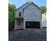 Two-story home's exterior is under construction with an attached two-car garage and gravel driveway at 1664 Crestridge Se Dr, Marietta, GA 30067