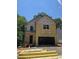 Two-story home featuring siding and an attached garage, set against a backdrop of lush trees on a sunny day at 1664 Crestridge Se Dr, Marietta, GA 30067