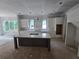 Spacious kitchen featuring white cabinets, a gray island, and large windows at 1664 Crestridge Se Dr, Marietta, GA 30067