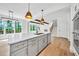 Modern kitchen with a center island, stainless steel appliances, hardwood floors, and an open view at 1664 Crestridge Se Dr, Marietta, GA 30067