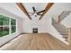 Open living room features hardwood floors, fireplace, exposed beams, and large windows with a view at 1664 Crestridge Se Dr, Marietta, GA 30067