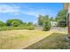 Expansive grassy backyard with mature trees and partial views of surrounding neighborhood homes at 1220 Hightower Nw Rd, Atlanta, GA 30318