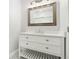 Bright bathroom boasts a classic vanity with white countertop and a framed mirror at 1220 Hightower Nw Rd, Atlanta, GA 30318