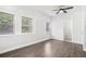 Bedroom featuring hardwood floors, three windows, a ceiling fan, and bathroom at 1220 Hightower Nw Rd, Atlanta, GA 30318