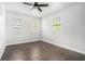 Bright bedroom featuring hardwood floors, three windows, and a ceiling fan at 1220 Hightower Nw Rd, Atlanta, GA 30318