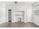 Bedroom with hardwood floors, fireplace, closet with shelving, and natural light at 1220 Hightower Nw Rd, Atlanta, GA 30318