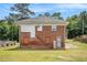 Rear elevation of brick home showcasing functional layout with access to backyard and upper level at 1220 Hightower Nw Rd, Atlanta, GA 30318